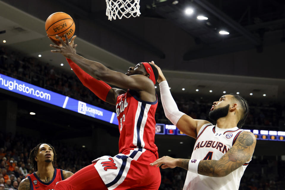 Mississippi forward Moussa Cisse shoots as Auburn forward Johni Broome (4) defends during the first half of an NCAA college basketball game Saturday, Jan. 20, 2024, in Auburn, Ala. (AP Photo/Butch Dill)