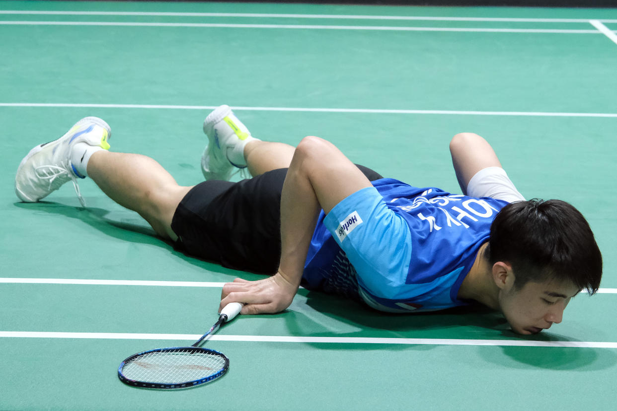 Singapore shuttler Loh Kean Yew falls to the court while retrieving a shot against Thailand's Kunlavut Vitidsarn at the Malaysia Open. 