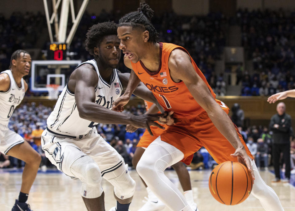 Virginia Tech's David N'Guessan (1) drives as Duke's AJ Griffin, left, defends during the first half of an NCAA college basketball game in Durham, N.C., Wednesday, Dec. 22, 2021. (AP Photo/Ben McKeown)