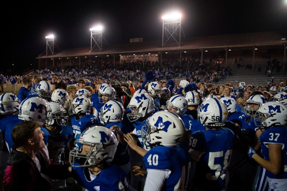 The Memorial Tigers celebrate their victory over the Jasper Wildcats in the Class 4A sectional semifinal game at Enlow Field in Evansville, Ind., Friday, Oct. 28, 2022. 