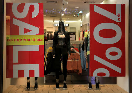 A clothing store window shows placards announcing discounts in Beirut, Lebanon September 28, 2018. REUTERS/Jamal Saidi