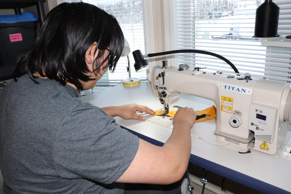 A student participating in the Northern Cultural Expressions Society's regalia program in Whitehorse.