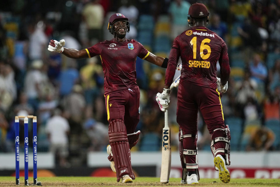 West Indies' Matthew Forde celebrates with teammate Romario Shepherd after defeating England by four wickets in the third ODI cricket match at Kensington Oval in Bridgetown, Barbados, Saturday, Dec. 9, 2023. (AP Photo/Ricardo Mazalan)