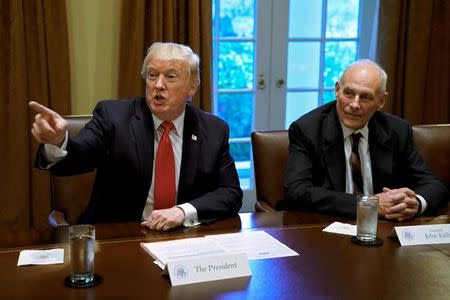 U.S. President Donald Trump gestures next to White House Chief of Staff John Kelly during a briefing with senior military leaders at the White House in Washington, DC, U.S., October 5, 2017. REUTERS/Yuri Gripas/Files