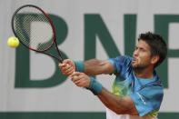 Fernando Verdasco returns the ball. REUTERS/Pascal Rossignol