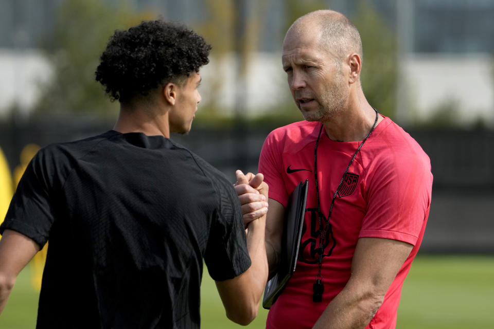 United States men's national soccer team head coach Gregg Berhalter, right, talks with forward Kevin Paredes during practice Monday, Sept. 4, 2023, in St. Louis. The U.S. is set to play a friendly against Uzbekistan this Saturday in St. Louis. (AP Photo/Jeff Roberson)