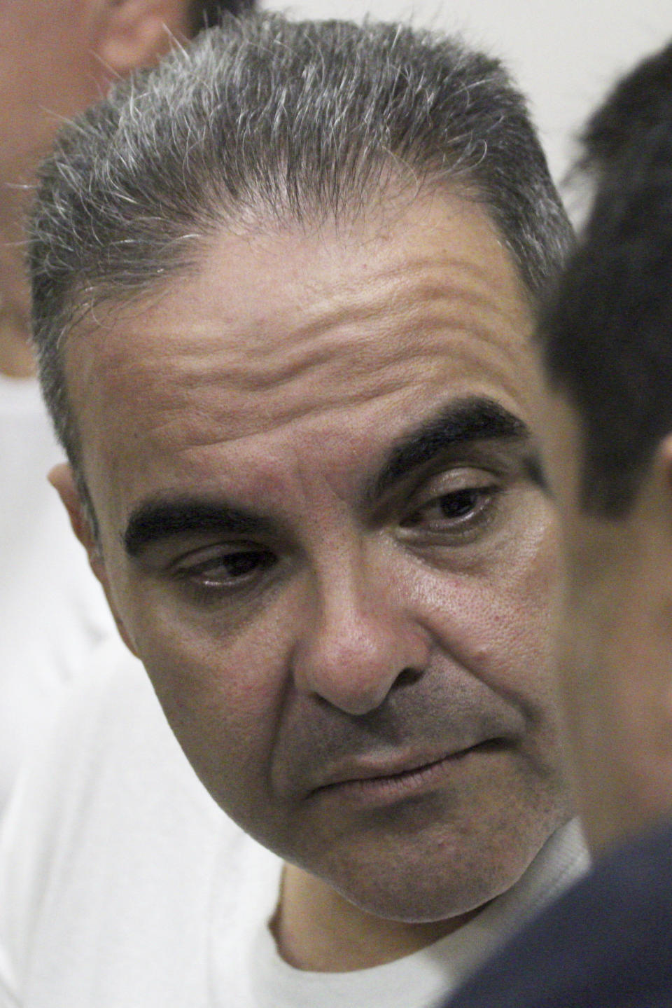 El Salvador's former President Tony Saca talks to his lawyer during an audience with a judge at the Isidro Menendez Judicial Complex in San Salvador, El Salvador, Wednesday, Sept. 12, 2018. Saca was sentenced to 10 years in prison for corruption Wednesday after pleading guilty to diverting more than $300 million in state funds. (AP Photo/Salvador Melendez)