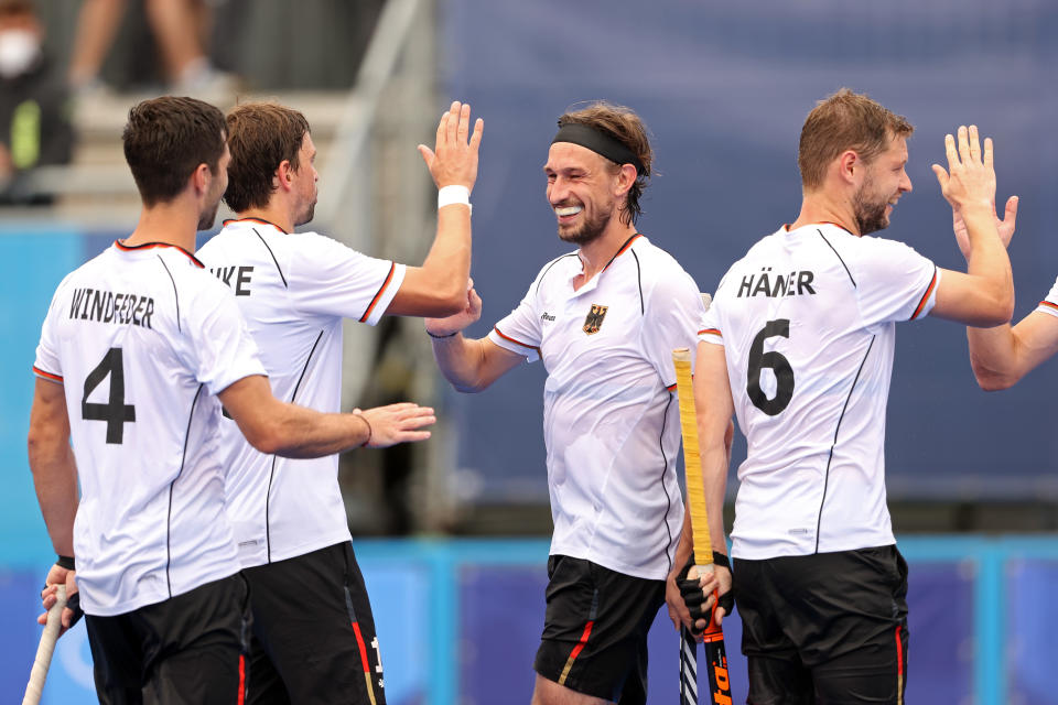 TOKYO, JAPAN - JULY 27: Florian Fuchs of Team Germany scores the fifth goal and celebrates with teammates during the Men's Preliminary Pool B match between Great Britain and Germany on day four of the Tokyo 2020 Olympic Games at Oi Hockey Stadium on July 27, 2021 in Tokyo, Japan. (Photo by Alexander Hassenstein/Getty Images)