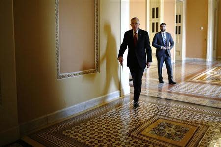 U.S. Senate Majority Leader Harry Reid (D-NV) (C) walks to address reporters after the weekly Republican caucus luncheon at the U.S. Capitol in Washington March 11, 2014. REUTERS/Jonathan Ernst