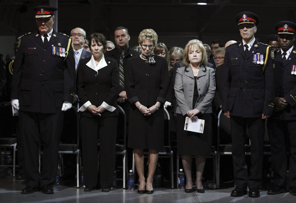 Ontario Premier Kathleen Wynne (C) attends the public memorial for police constable John Zivcic in Toronto