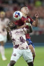 Portland Timbers' Franck Boli and Real Salt Lake midfielder Braian Ojeda, rear, compete for the ball during the first half of an MLS soccer match Wednesday, May 17, 2023, in Sandy, Utah. (AP Photo/Rick Bowmer)