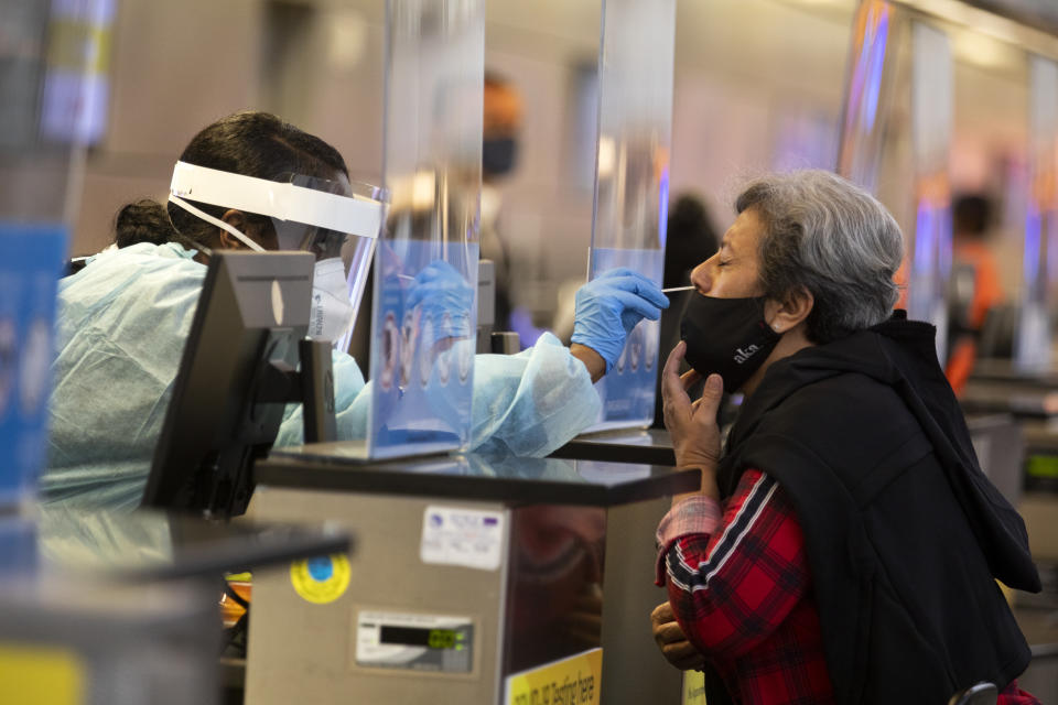 A traveler is tested for COVID-19 in Tom Bradley International at LAX  on Nov. 17, 2020 in Los Angeles, CA. Los Angeles International Airport started issuing molecular or PCR tests  this week and has plans to quickly expand the program in order to help detect coronavirus and slow its spread. (Francine Orr/Los Angeles Times via Getty Images)