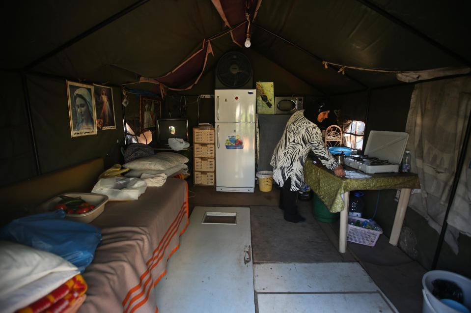 Lebanese Majida Bashasha, 60, sister of Ahmad who was kidnapped in 1975 at the age of 18, works inside a tent called the "missing tent" which was set up nine years ago for an ongoing sit-in by the relatives of those who missed in Syria, in front the U.N headquarters, in downtown Beirut, Lebanon, Friday April 11, 2014. Elie and Milad are among an estimated 17,000 Lebanese still missing from the time of Lebanon’s civil war or the years of Syrian domination that followed. Syria’s civil war has added new urgency to the plight of their families, many of whom are convinced their loved ones are still alive and held in Syrian prisons, at risk of being lost or killed in the country’s mayhem. (AP Photo/Hussein Malla)