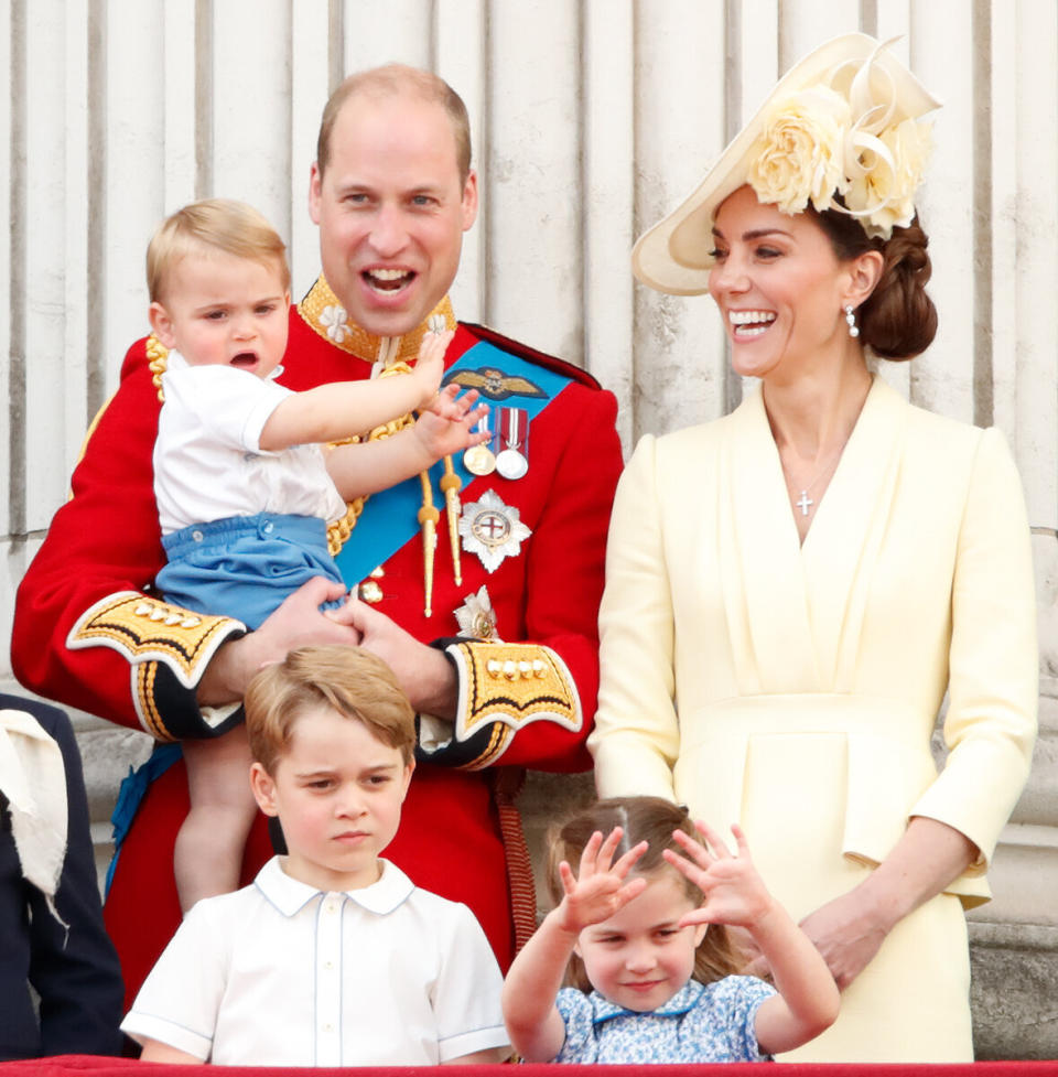 William, Kate, Prince George, Princess Charlotte and Prince Louis (in the duke's arms) watch a flyover from the balcony of Buckingham Palace during Trooping The Colour, the Queen's annual birthday parade, on June 8 in London.