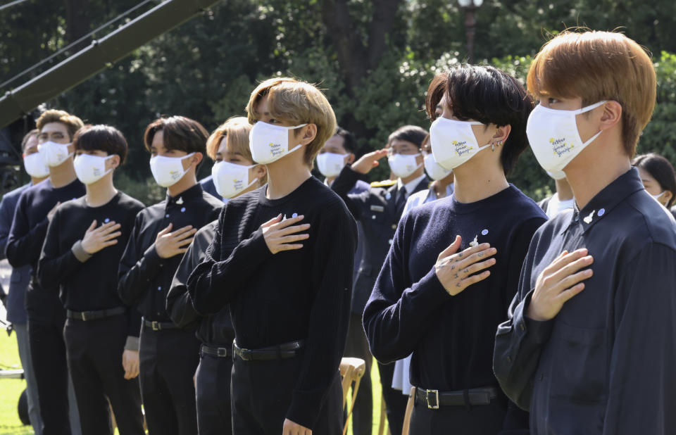 FILE - In this Sept. 19, 2020, file photo, South Korean K-pop group BTS salutes to their national flag during a ceremony marking the National Youth Day at the presidential Blue House in Seoul, South Korea. BTS released a statement condemning racism against Asians and Asian Americans and Pacific Islanders (AAPI) on Tuesday, March 30, 2021. “We stand against racial discrimination,” the biggest boyband in the world, tweeted to their 34 million followers in both English and Korean. (Lee Jin-wook/Yonhap via AP)