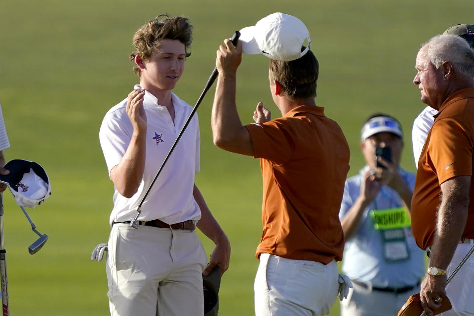 Vanderbilt golfer Gordon Sargent, left, greets Texas golfer Parker Coody after Sargent's victory in a four-way playoff during the final round of the NCAA college men's stroke play golf championship, Monday, May 30, 2022, in Scottsdale, Ariz. (AP Photo/Matt York)