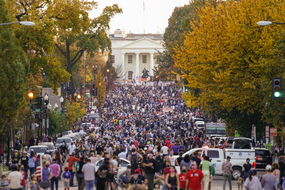 People gather along 16th street in front of the White House to celebrate the presidential race being called in favour of President-elect Joe Biden over President Donald Trump. (AP Photo/Pablo Martinez Monsivais)