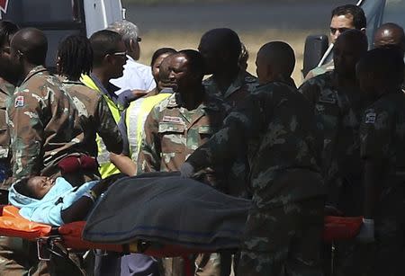 Members of the South African Army transport a pilgrim, who sustained injuries in a collapsed church guesthouse in Lagos and was evacuated from Nigeria, upon arriving at an air force base north of Johannesburg September 22 2014. REUTERS/Siphiwe Sibeko