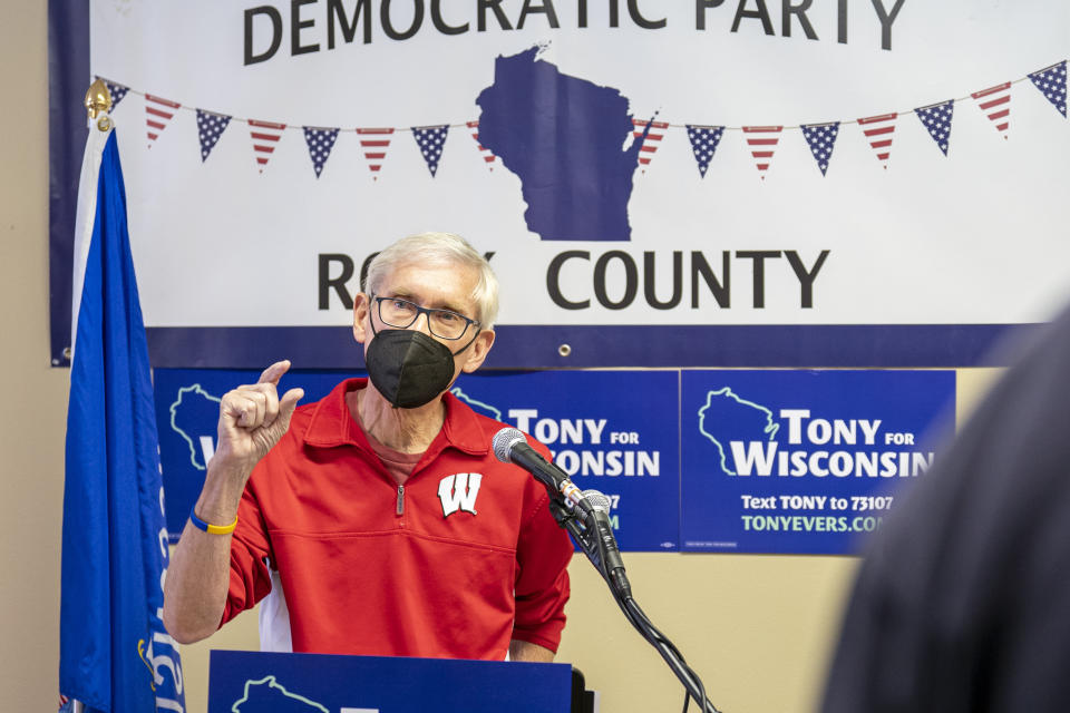 Wisconsin Gov. Tony Evers gestures during an address to about 50 people at a party headquarters in downtown Janesville, Wis., Saturday, Jan. 8, 2022. To win reelection, the 70-year-old grandfather and former teacher is trying to convince voters that he’s also a valiant defender of democracy and the lone figure ensuring their votes will still matter in 2024 and beyond. (AP Photo/Andy Manis)