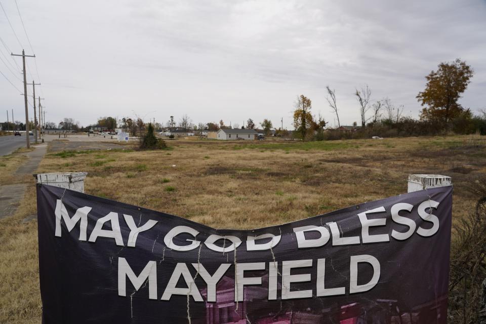 A banner reading "May God Bless Mayfield" hangs near empty lots, Thursday, Nov. 9, 2023, in Mayfield, Ky. In December 2021, a tornado destroyed parts of the town and killed dozens. (AP Photo/Joshua A. Bickel)