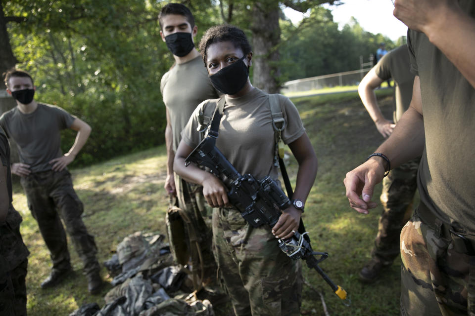 Niara Pelton, of Houston, Texas, carries her M-4 Carbine during drills, Friday, Aug. 7, 2020, in West Point, N.Y. The pandemic is not stopping summer training at West Point. Cadets had to wear masks this year for much of the training in a wooded area just beyond the main gates of the U.S. Military Academy. (AP Photo/Mark Lennihan)