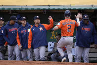 Houston Astros' Alex Bregman (2) celebrates with manager Dusty Baker Jr., right, after scoring against the Oakland Athletics on Corey Julks' single during the second inning of a baseball game in Oakland, Calif., Friday, May 26, 2023. (AP Photo/Godofredo A. Vásquez)