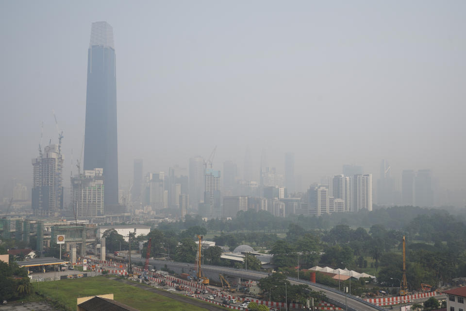 Kuala Lumpur city is shrouded with haze in Kuala Lumpur, Malaysia, Tuesday, Sept. 17, 2019. More than 100 schools were closed Tuesday after the air quality in the area continued to trend at very unhealthy levels. (AP Photo/Vincent Thian)