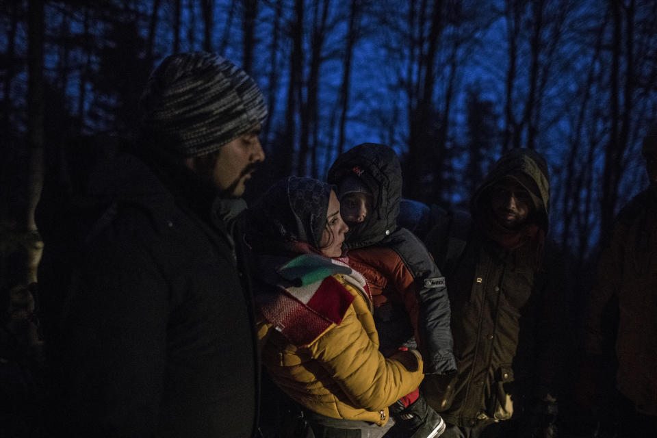 Indian migrant Suhil, 23, helps Syrian migrant Fatma, 24, to hold her son Omar, 1, while crossing the mountains between Bosnia and Croatia near the town of Bihac, northwestern Bosnia on Dec. 12, 2019. (Photo: Manu Brabo/AP)