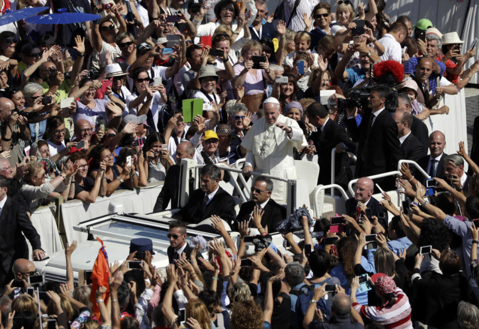 <p>Pope Francis waves to cheering faithful as he is driven through the crowd after celebrating a Jubilee Mass for catechists, at the Vatican, Sept. 25, 2016. (Photo: Andrew Medichini/AP)</p>