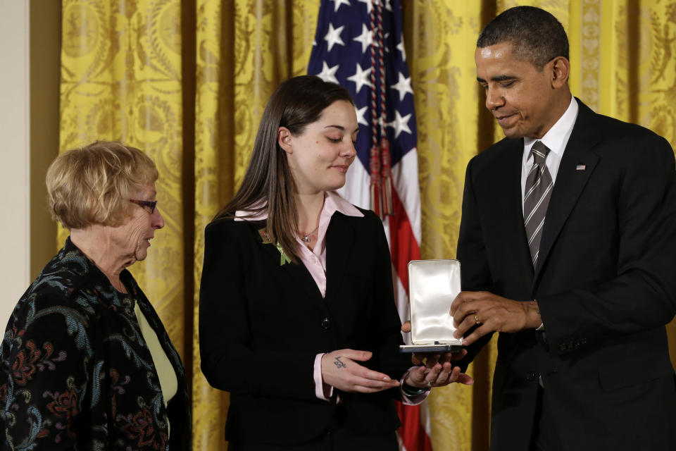 President Barack Obama presents a 2012 Citizens Medal to the family of Sandy Hook Elementary School Principal Dawn Hochsprung, Friday, Feb. 15, 2013, in the East Room of the White House in Washington. (AP Photo/Jacquelyn Martin)