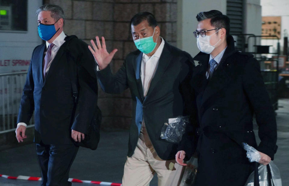 FILE - Hong Kong media tycoon Jimmy Lai, center, leaves the Hight Court after being granted bail in Hong Kong, on Dec. 23, 2020. The trial of a Hong Kong newspaper publisher who was arrested in a crackdown on a pro-democracy movement was postponed on Thursday, Dec. 1, 2022, after the territory's leader asked China to effectively block him from hiring a British defense lawyer. (AP Photo/Vincent Yu, File)