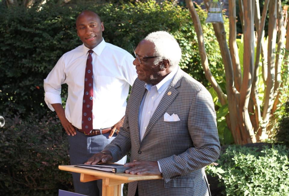 Shelby County Mayor Lee Harris, left, listens as former Shelby County Commissioner Walter Bailey speaks at a fundraiser at Bailey's home for Harris Wednesday, June 29, 2022.