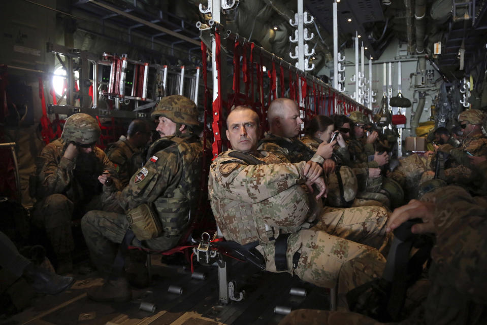 FILE - In this March 20, 2018 file photo, NATO soldiers fly in a U.S. Air Force C-130 aircraft during a routine movement of NATO troops, transporting them from Kandahar to Kabul. After 20 years of military engagement and billions of dollars spent, NATO and the United States still grapple with the same, seemingly intractable conundrum — how to withdraw troops from Afghanistan without abandoning the country to even more mayhem. (AP Photo/Rahmat Gul, File)