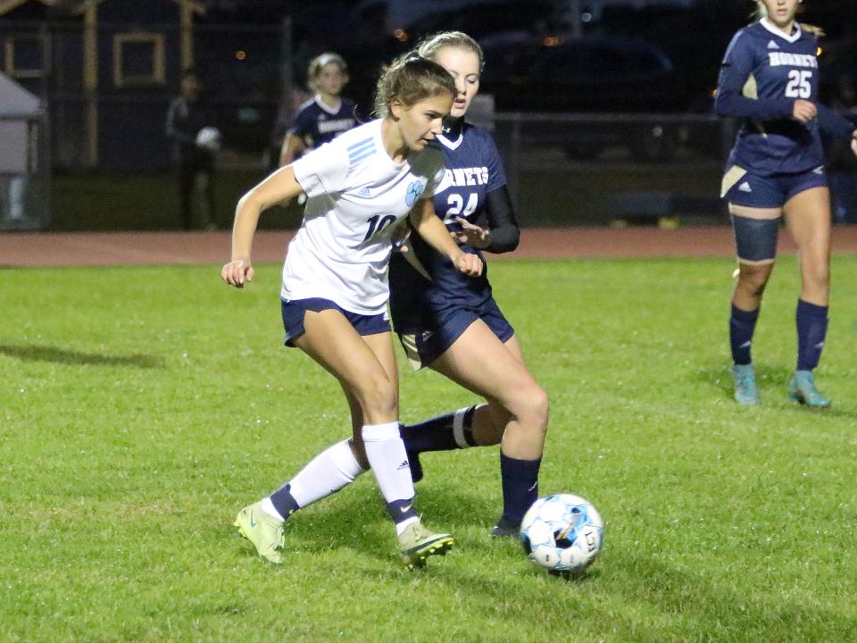 MMU's Chloe DeJong passes to a teammate during the Cougars' 1-0 win over Essex under the lights at EHS in 2022.