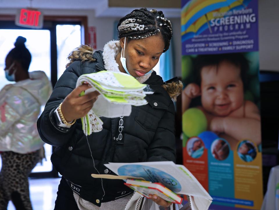 LaShawnda Gray, 6 months pregnant picks out baby items at the Ascension Wisconsin Blanket of Love baby shower at Ebenezer Health Resource Center.