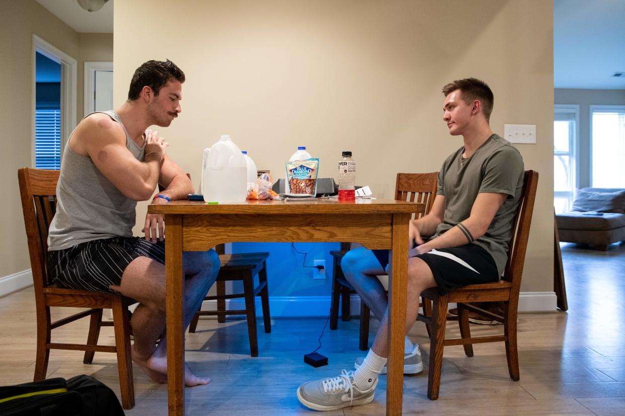 Liberty University student Jared Marshall, right, and his roommate and fellow student Jake Baker, sit inside their apartment near Lynchburg, Virginia, on March 31, 2020. (Photo by AMANDA ANDRADE-RHOADES/AFP via Getty Images)