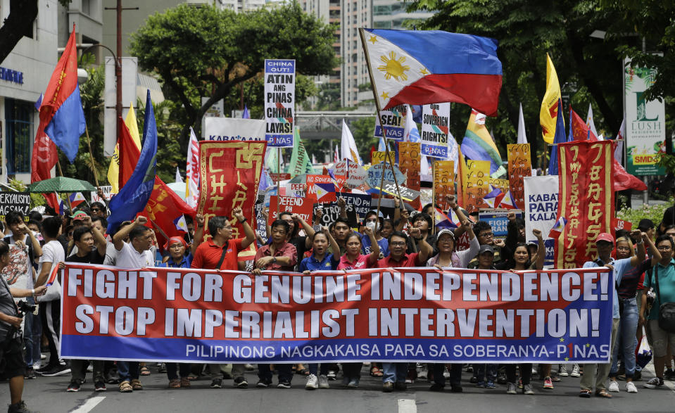 Protesters march towards the Chinese Consulate at the financial district of Makati, metropolitan Manila to mark Philippine Independence Day on Wednesday, June 12, 2019. The group said they condemn the administration of Philippine President Rodrigo Duterte for its alleged subservience to the dictates of U.S. and China. They also demanded that China must stop its continued occupation of the disputed South China Sea because it disrespects sovereign rights. (AP Photo/Aaron Favila)