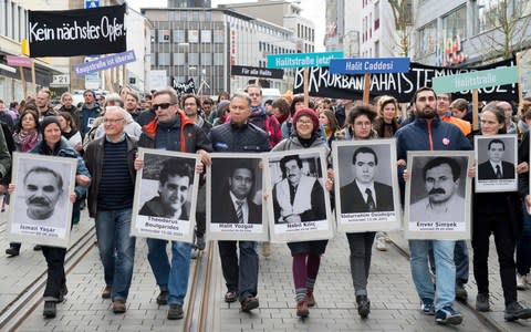 Protesters with 'Kein naechstes Opfer!' - 'No other victim!' - in Kassel, Germany hold posters of the people killed by the far-Right NSU cell - Credit: Swen Pfoertner/dpa