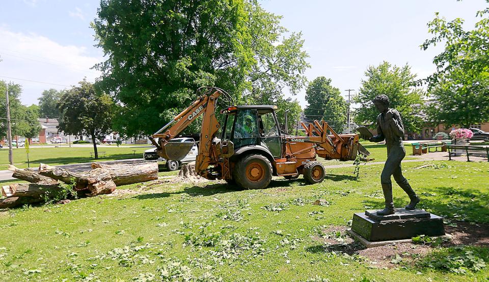 Village of Loudonville's maintenance workers clear the large tree that came down in Central Park near the Kettering statue and water fountain on Wednesday, June 15, 2022. TOM E. PUSKAR/ASHLAND TIMES-GAZETTE