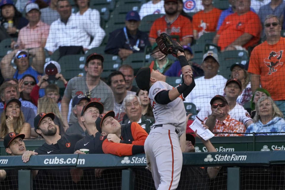 Baltimore Orioles first baseman Ryan Mountcastle catches a popup by Chicago Cubs' Willson Contreras in front of the Baltimore dugout during the first inning of a baseball game Wednesday, July 13, 2022, in Chicago. (AP Photo/Charles Rex Arbogast)