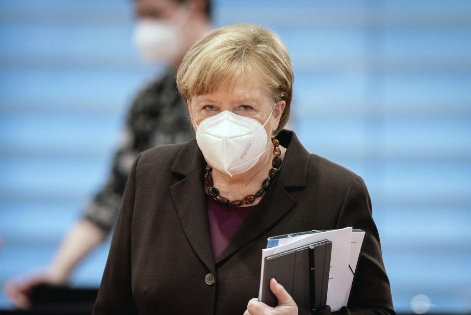 German Chancellor Angela Merkel wearsa face mask as she arrives for the weeekly cabinet meeting at the Chancellery in Berlin, Germany, Wednesday, Feb. 24, 2021. (Kay Nietfeld/dpa via AP, Pool)