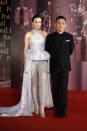 Hong Kong actor Tony Leung, nominated for Best Actor for his role in "The Grandmaster", poses with his wife, actress Carina Lau, on the red carpet during the 33rd Hong Kong Film Awards in Hong Kong April 13, 2014. REUTERS/Tyrone Siu (CHINA - Tags: ENTERTAINMENT)