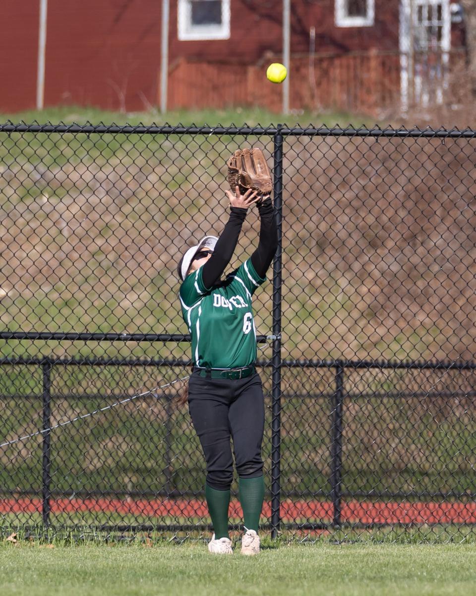 Dover outfielder Sonya Castonguay makes a catch at the fence off the bat of Winnacunnet's Halisa Carter during Friday's Division I softball game.