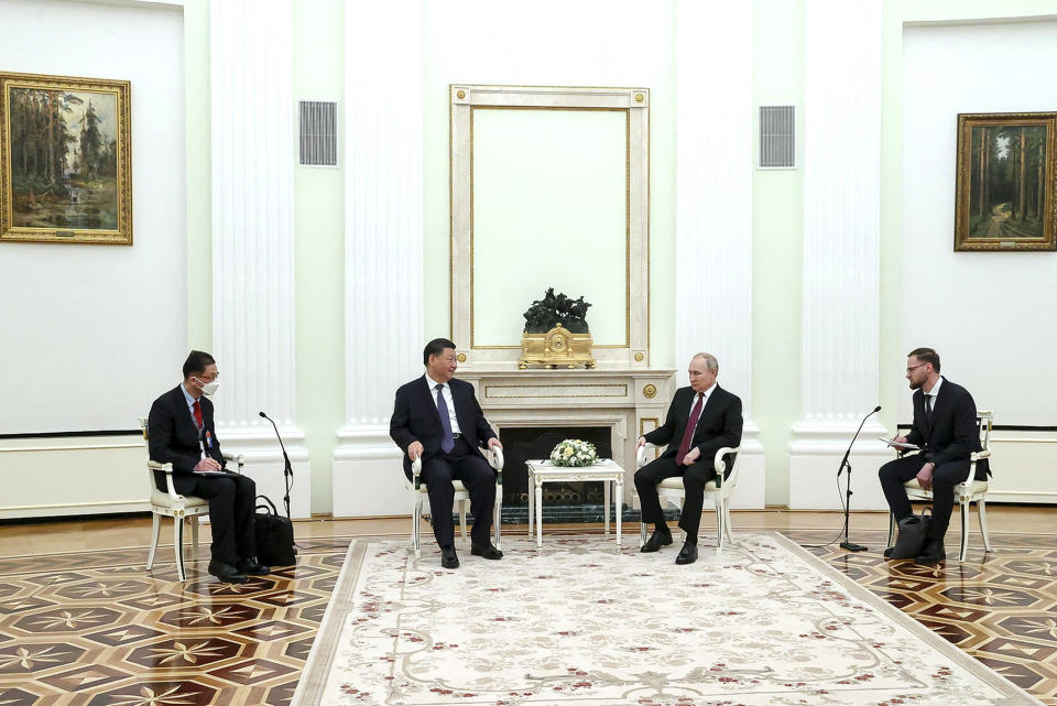 In this handout photo released by Russian Presidential Press Office, Russian President Vladimir Putin, center right, and Chinese President Xi Jinping, center left, talk to each other during their meeting at the Kremlin in Moscow, Russia, Monday, March 20, 2023. (Russian Presidential Press Office via AP)