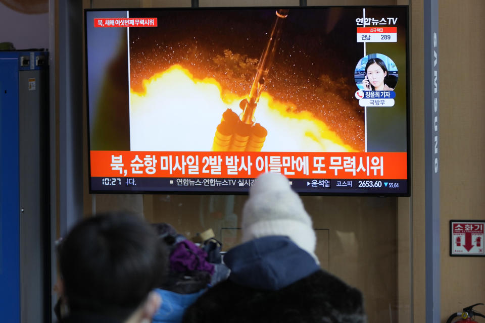 People watch a TV screen showing a news program reporting about North Korea's missile launch with a file image, at a train station in Seoul, South Korea, Thursday, Jan. 27, 2022. North Korea on Thursday fired at least two suspected ballistic missiles into the sea in its sixth round of weapons launches this month, South Korea's military said. The letters read "North, fired two missiles." (AP Photo/Lee Jin-man)