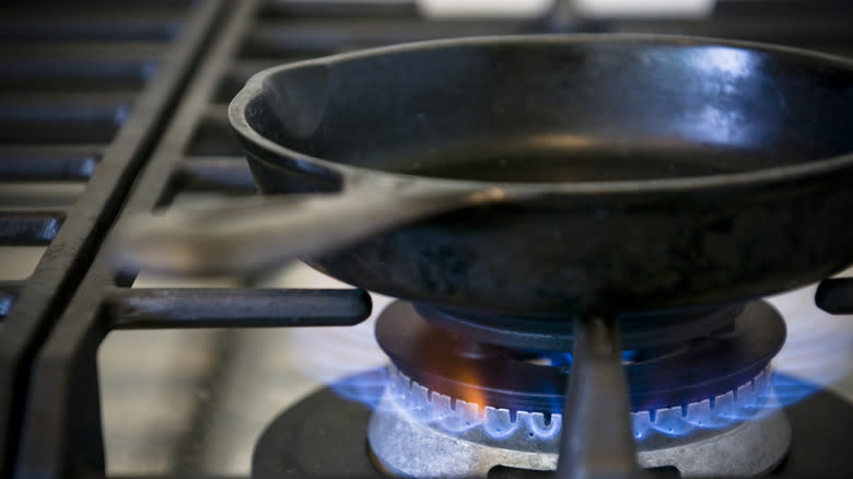 A cast iron pan on a stove-top burner