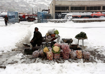 An Afghan man sells vegetables as he waits for customers on a snowy day in Kabul, Afghanistan February 5, 2017.REUTERS/Omar Sobhani