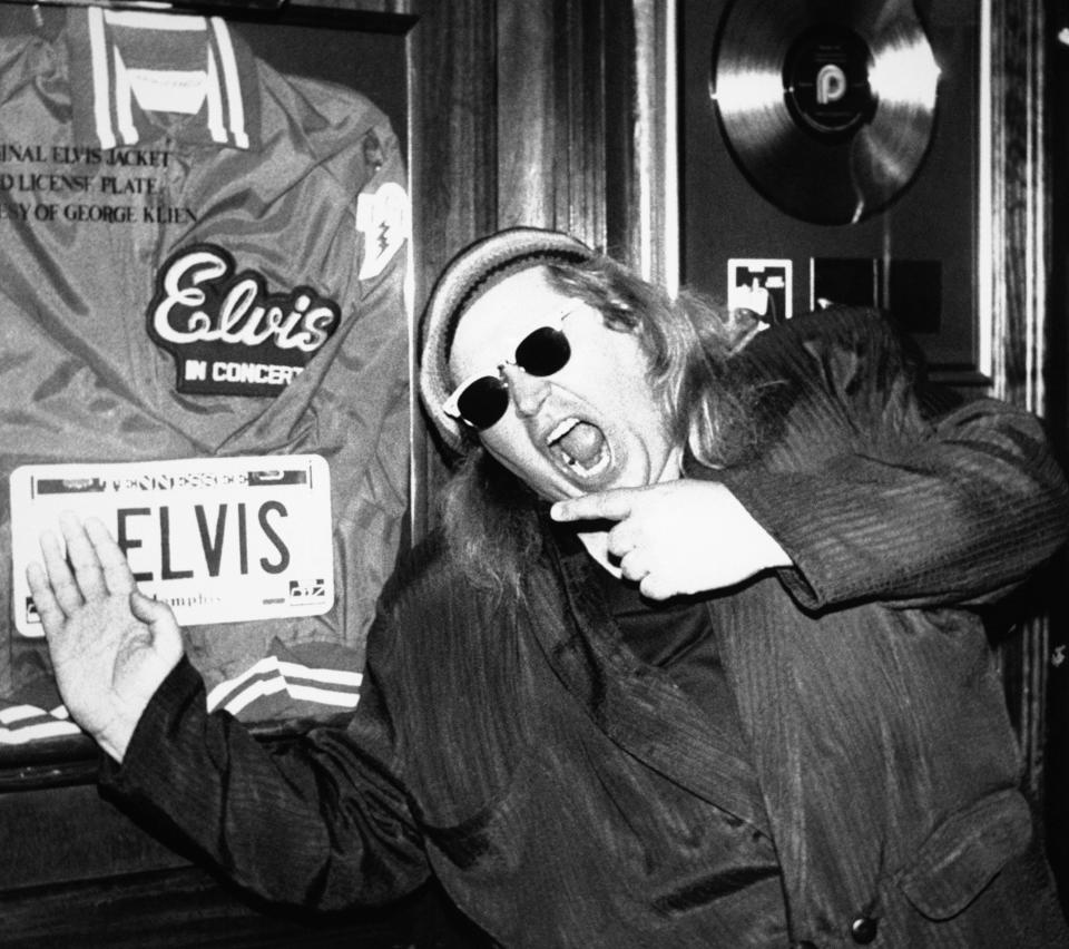 In this June 10, 1988 file photo, comedian Sam Kinison, known for his bellowed outbursts, poses at New York's Hard Rock Cafe where he was filming a promo for MTV.