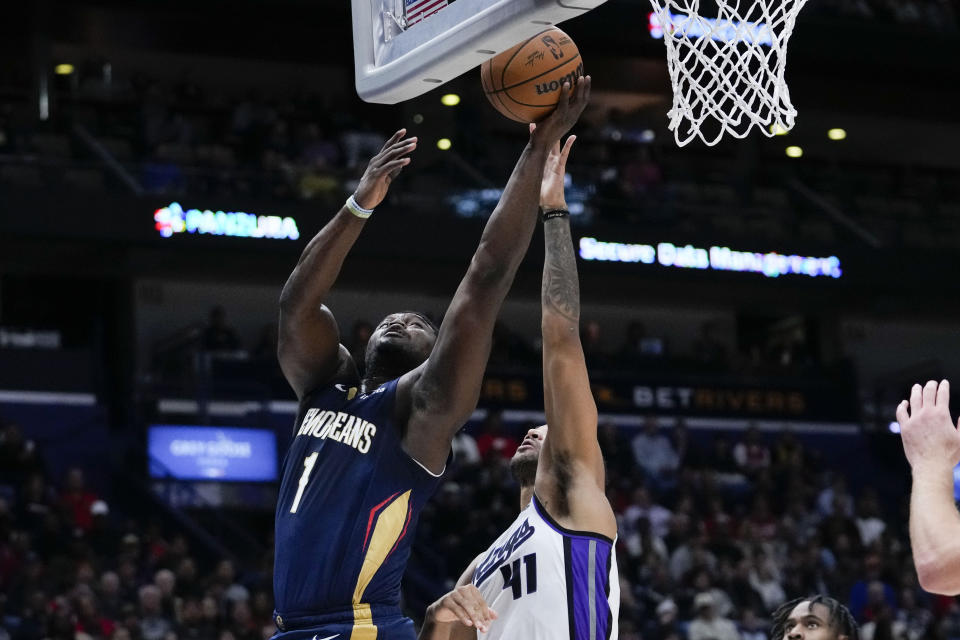 New Orleans Pelicans forward Zion Williamson (1) goes to the basket against Sacramento Kings forward Trey Lyles (41) in the first half of an NBA basketball game in New Orleans, Wednesday, Nov. 22, 2023. (AP Photo/Gerald Herbert)