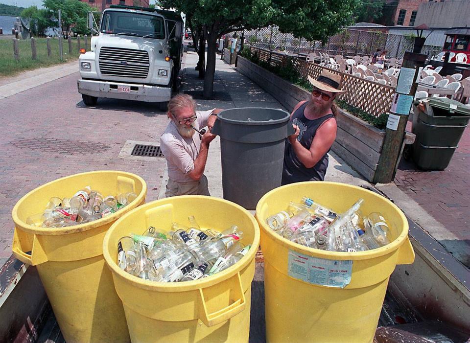 Jim Bath, left, and Joe Carney of the IceHouse loading trash cans full of beer bottles which to take the recycling center, early 2000s.
